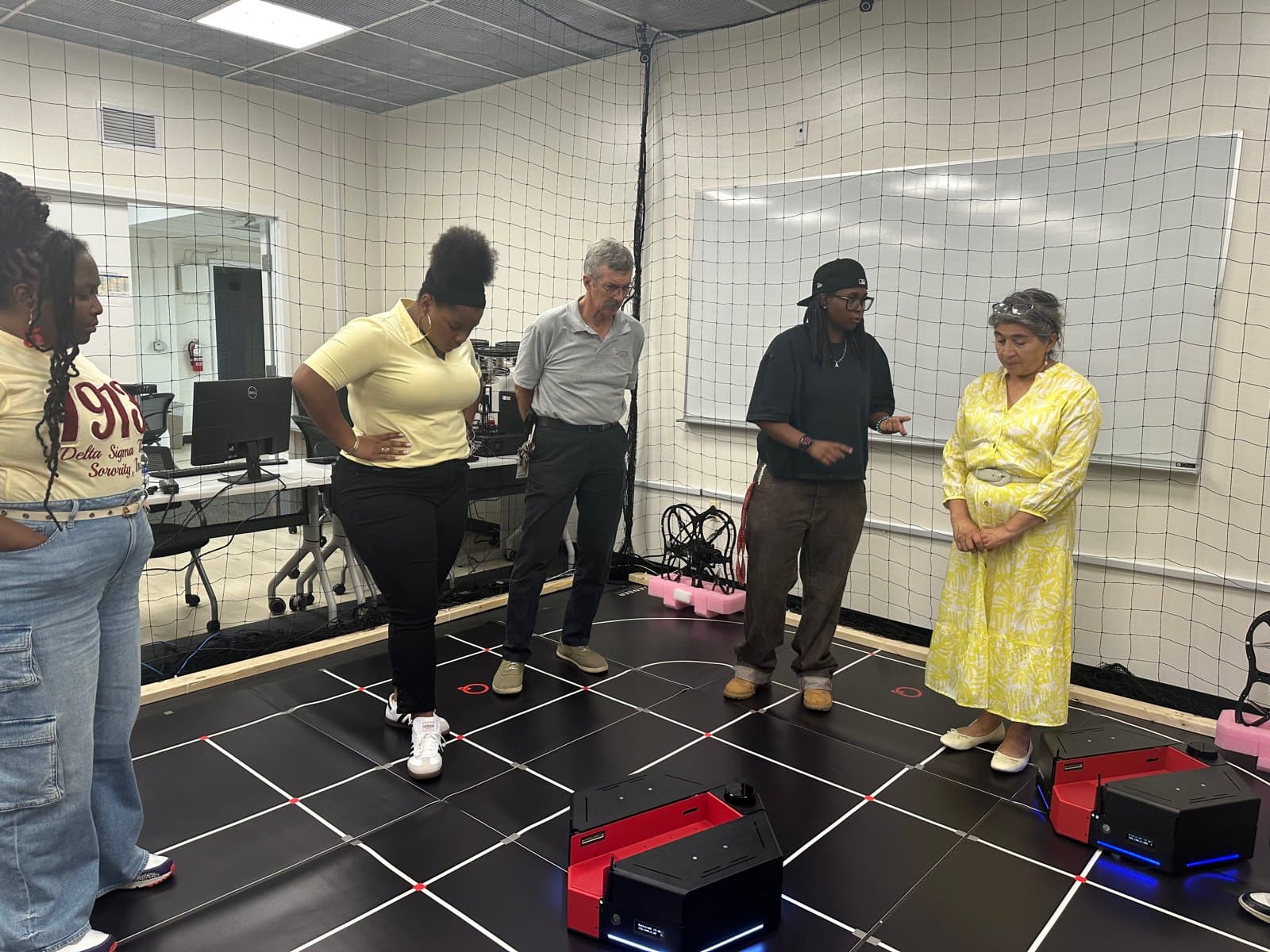 Educators observing mobile robotics platforms during RAOP 2026.